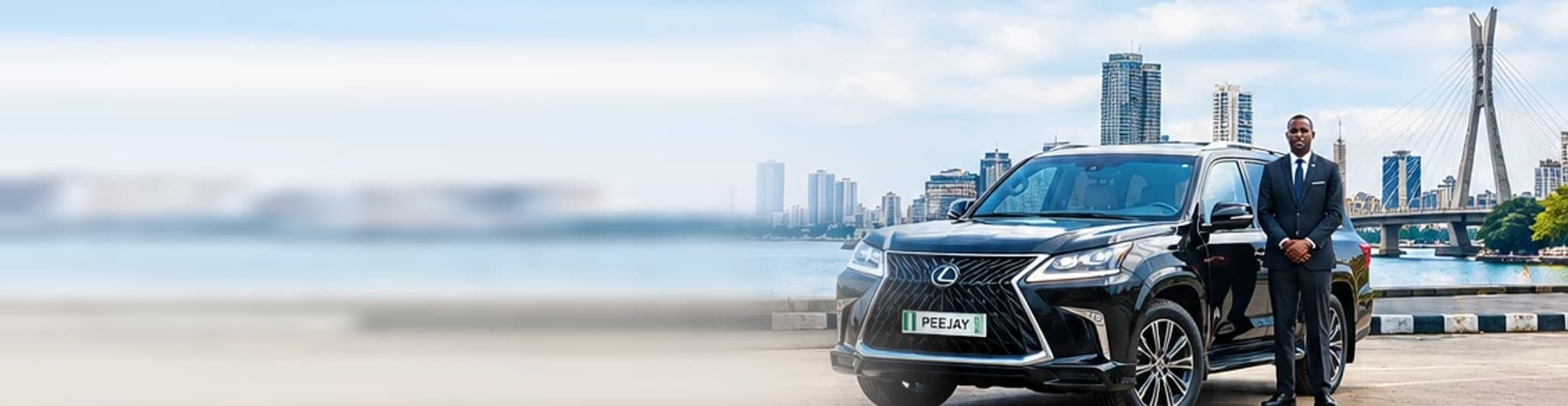 A chauffeur in a dark suit standing beside a black Lexus LX570 on the Lagos waterfront, with the Victoria Island skyline and the Lekki-Ikoyi bridge behind